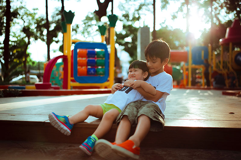 two-kids-hugging-on-playground